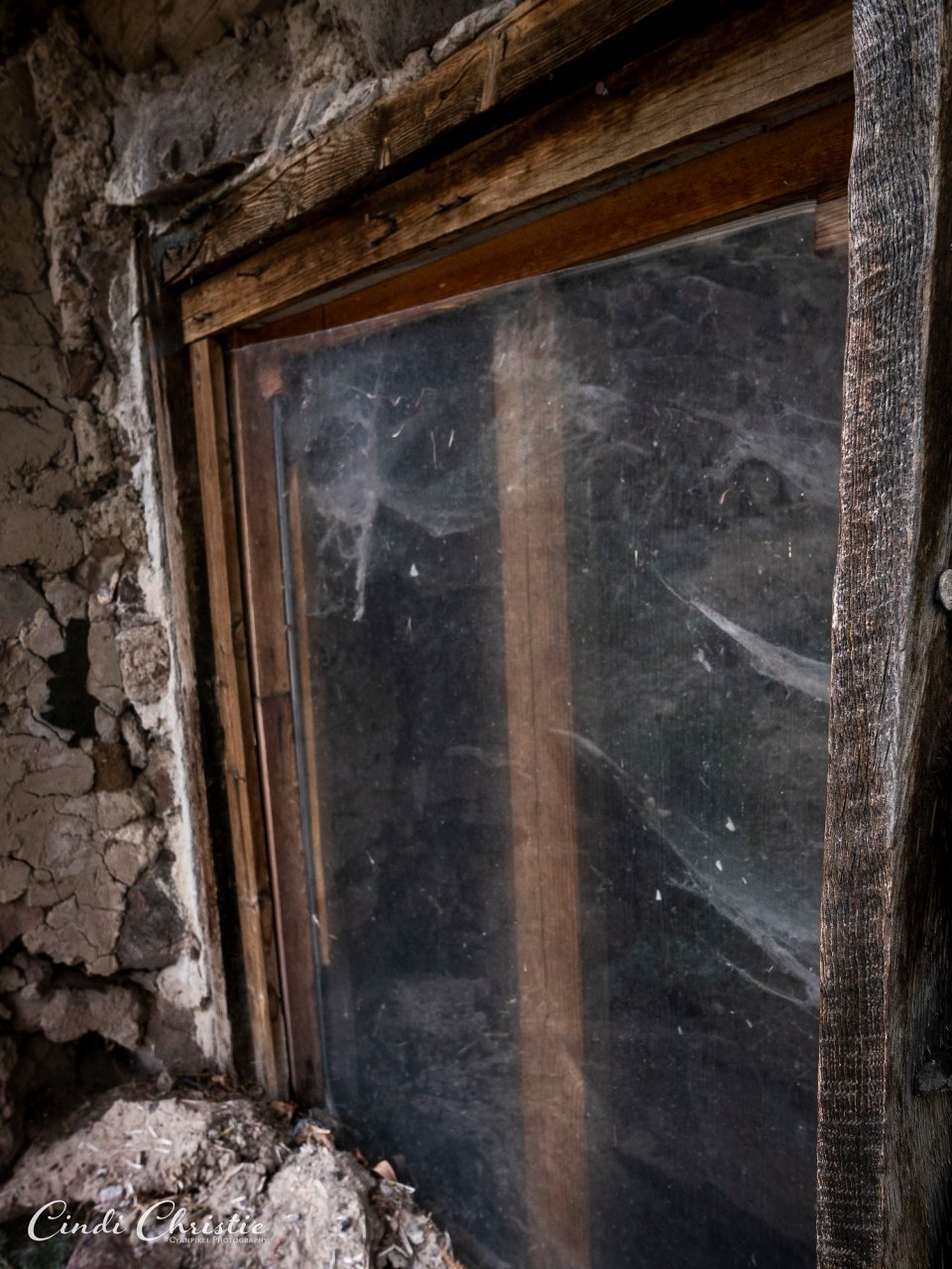 A dusty window offers a glimpse into this structure's interior,